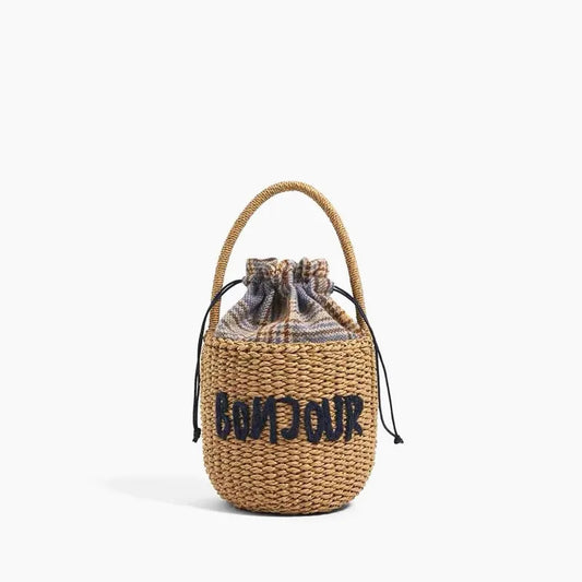 Sac à Main Panier en Paille avec Broderie, de couleur marron, avec inscription "bonjour", sur un fond blanc.
