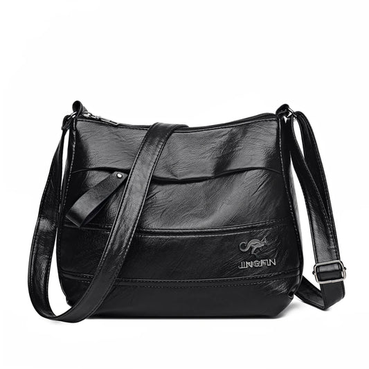 Sac à Main en Simili Femme avec Bandoulière, multipoche, de couleur noir, sur un fond blanc.