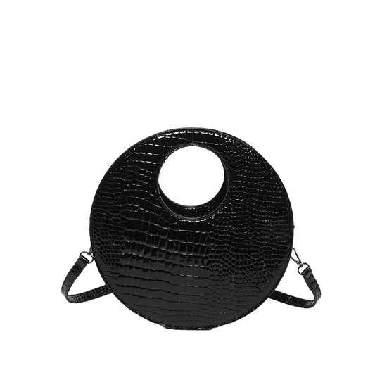 Sac à Main Rond Effet Crocodile, de couleur noire, sur fond blanc.