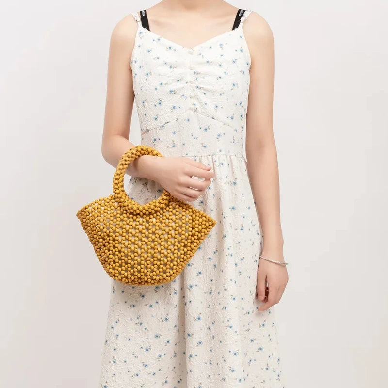 Sac à Main Panier Perle en Bois, porté par un mannequin.